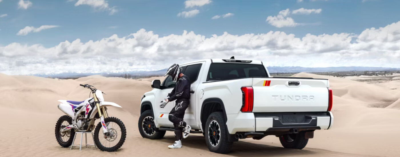 2026 Toyota Tundra in the desert with dirt bike rider