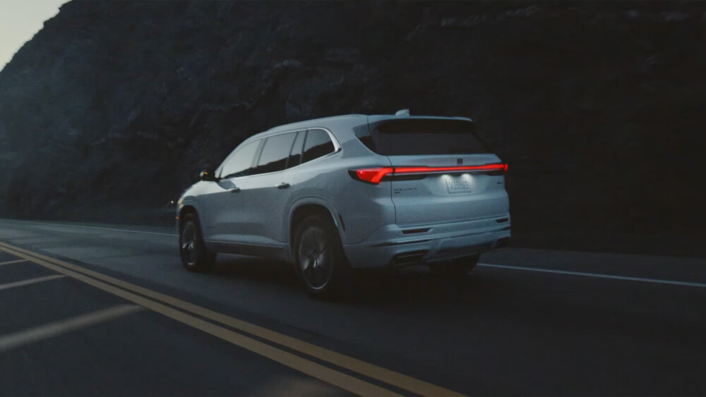 2026 White Buick Enclave driving on dark highway