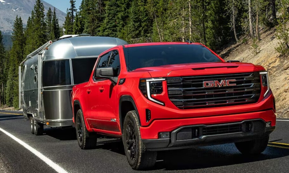 Red 2026 GMC Sierra 1500 towing trailer