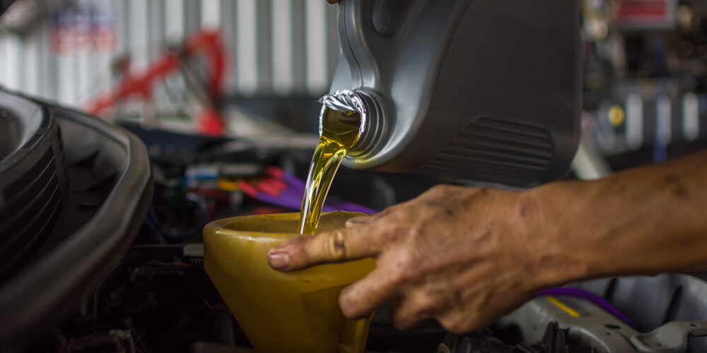 Mechanic performing oil change Mechanic performing oil change