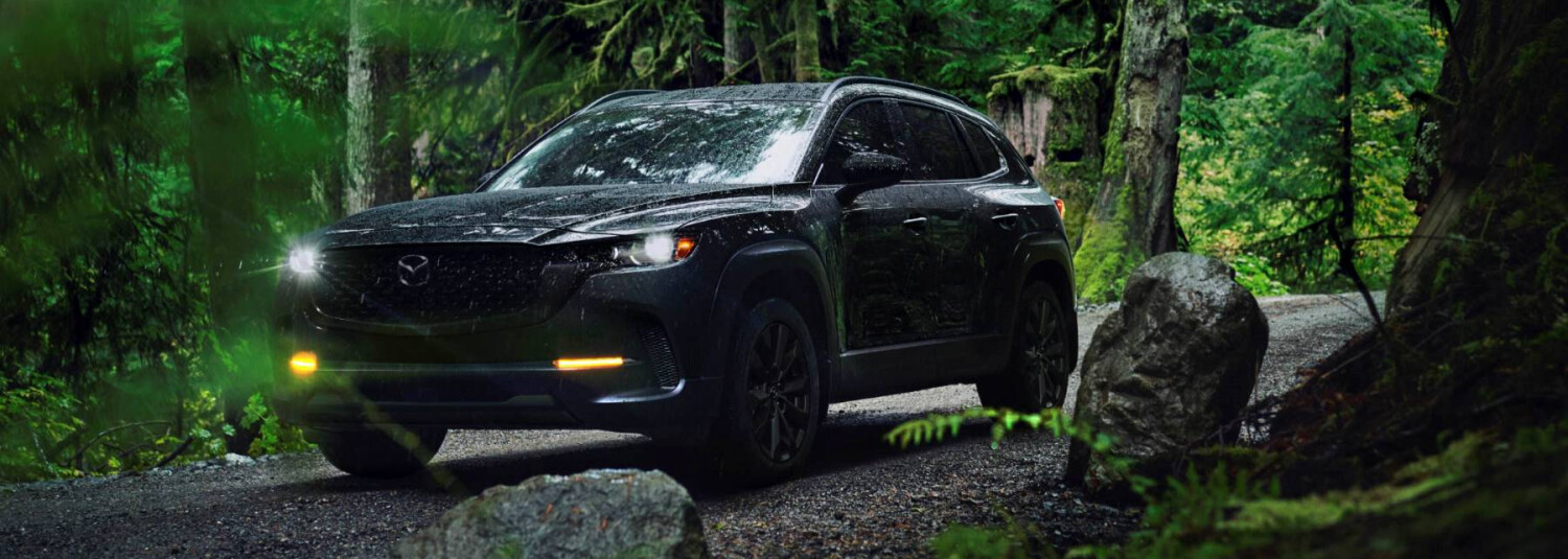 2026 MAZDA CX-50 outside with foliage