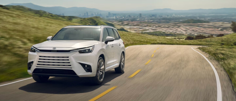 2026 Lexus TX on country road with city in background