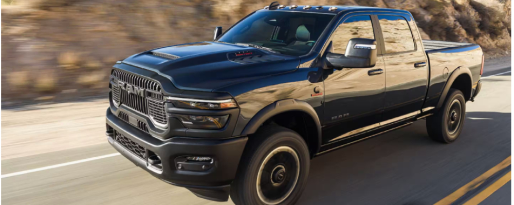 2025 RAM 2500 A black RAM 2500 is driving along a mountain road.
