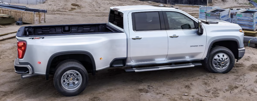2024 Chevy Silverado 3500HD A white Chevy Silverado 3500hd is parked on a worksite.