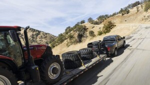 2025 RAM 3500 towing a tractor and tires