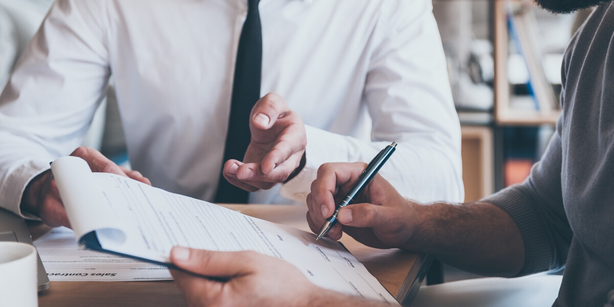 Man Signing Paperwork