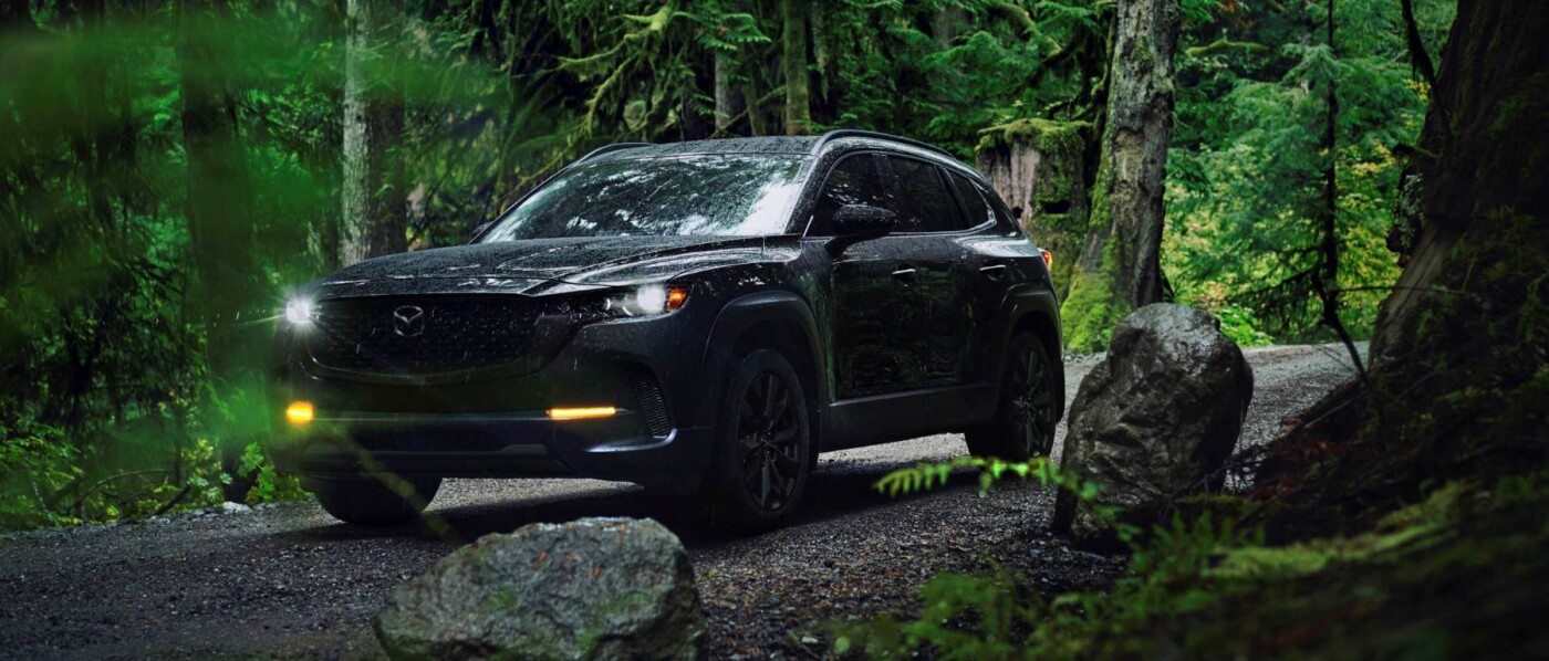 2026 MAZDA CX-50 outside with foliage