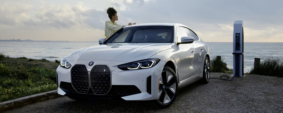 A white 2024 BMW i4 charging
