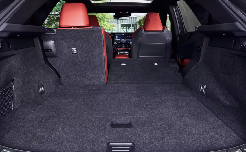 The inside of this car has black carpet and red leather seats. 
