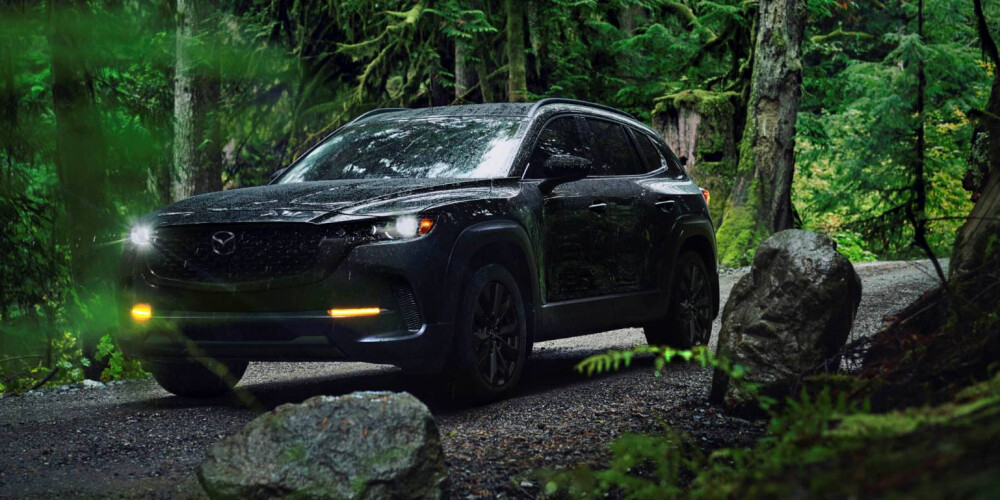 2026 MAZDA CX-50 outside with foliage