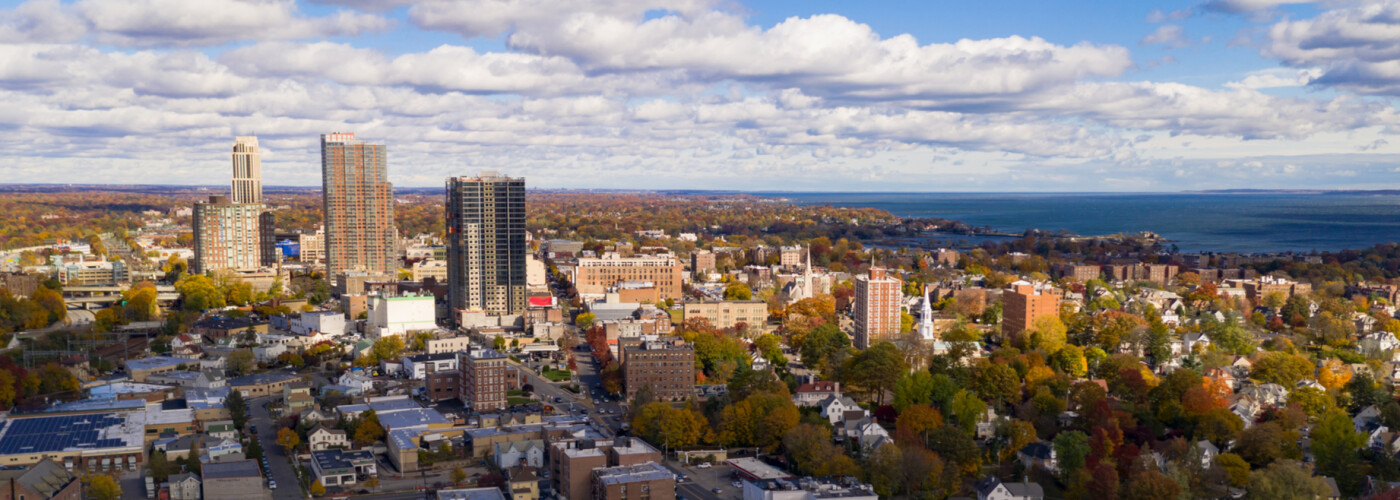 The Sun breaks through clouds hitting and illuminating the urban core of New Rochelle, New York 