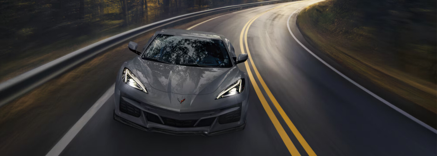 2025 Chevrolet Corvette E-Ray 2025 Chevrolet Corvette E-Ray driving down forest highway