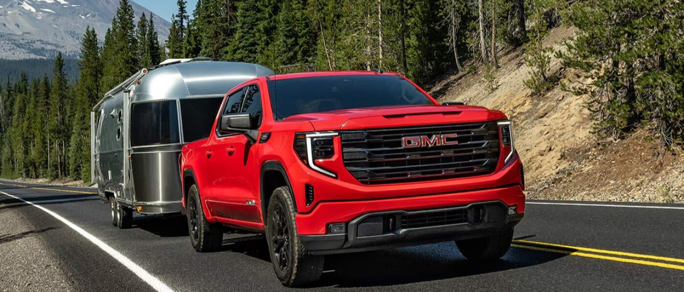 Red 2026 GMC Sierra 1500 towing trailer