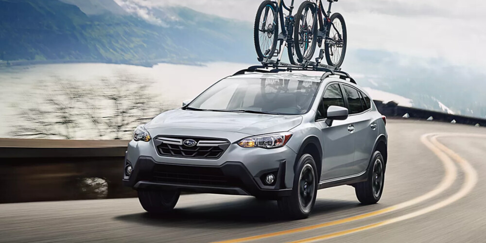a 2023 Subaru Crosstrek driving down the road